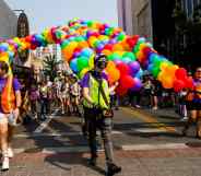 A group of people march with pride balloons in Nevada