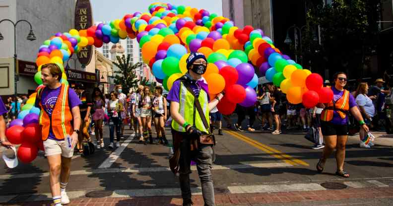 A group of people march with pride balloons in Nevada