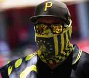 One of the members from the far-right group Proud Boys wearing a black and yellow bandana, cap and sunglasses