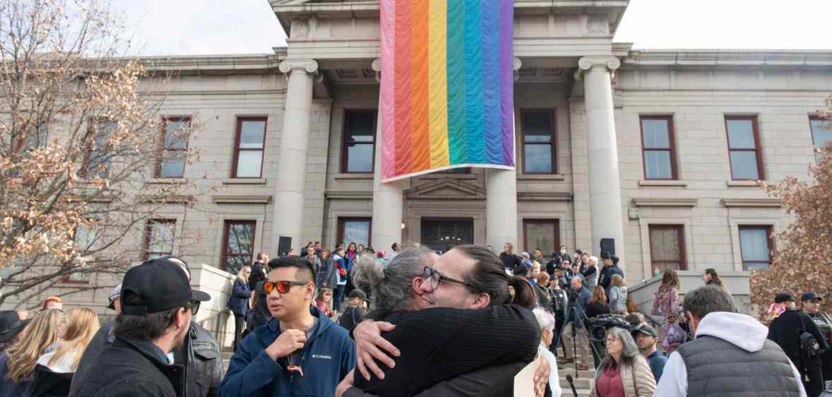 Autumn Quinn (center at bottom) hugs a person during a ceremony at Colorado Springs City Hall in Colorado Springs.
