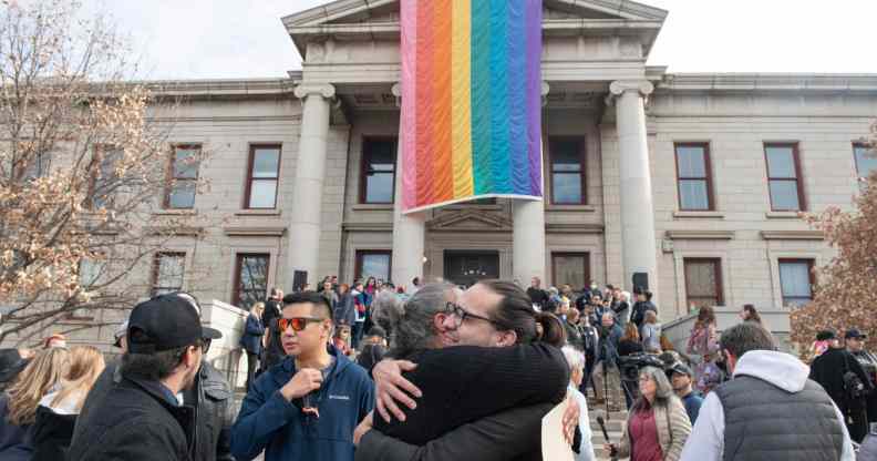 Autumn Quinn (center at bottom) hugs a person during a ceremony at Colorado Springs City Hall in Colorado Springs.