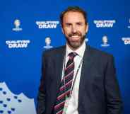 England manager Gareth Southgate wearing a navy coloured suit jacket and tie over a white shirt smiles to the camera at the UEFA Euro 2024 Qualifying Group Stage Draw - Ceremony