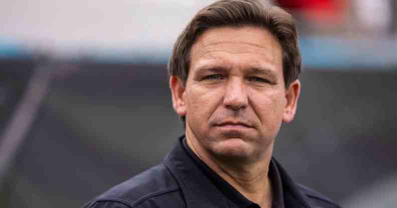 Florida Governor Ron DeSantis wearing a black shirt and jacket looks on before the start of a game between the Georgia Bulldogs and the Florida Gators