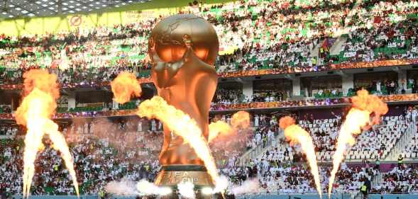 Pyrotechnics explode around a giant FIFA World Cup trophy prior to the FIFA World Cup Qatar 2022 Group A match between Qatar and Senegal