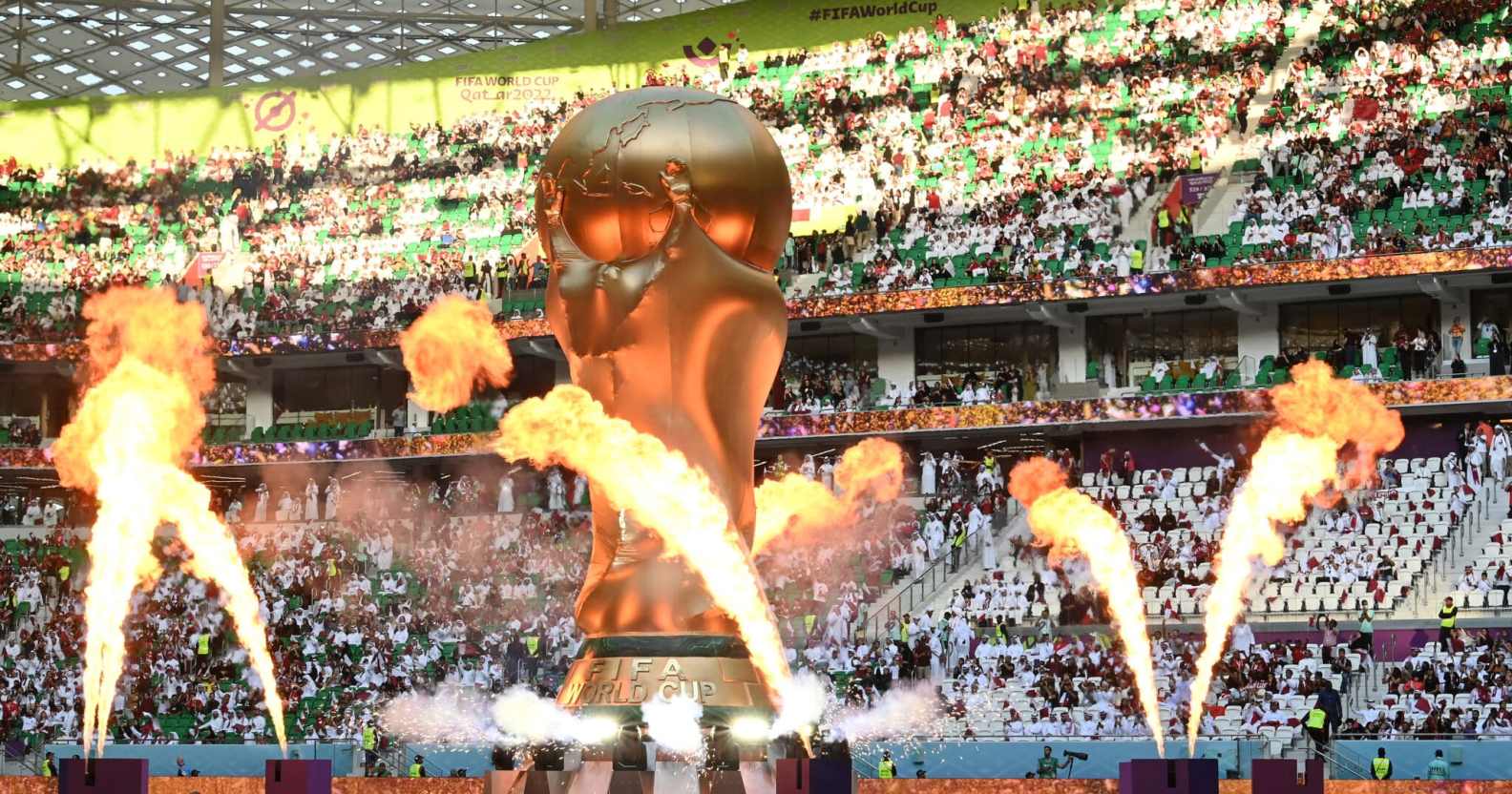 Pyrotechnics explode around a giant FIFA World Cup trophy prior to the FIFA World Cup Qatar 2022 Group A match between Qatar and Senegal