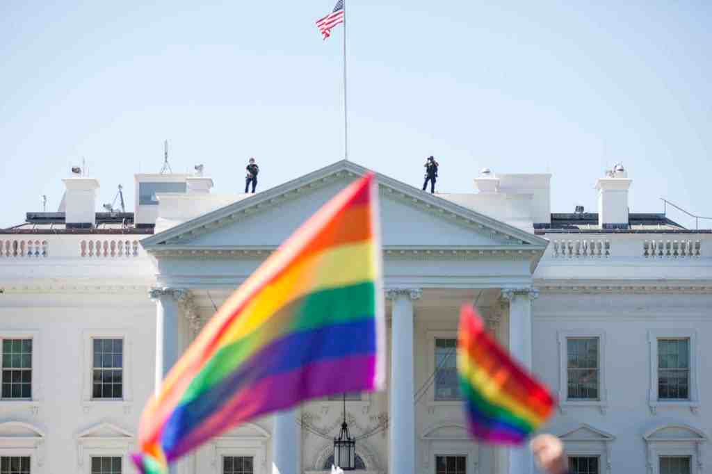 Pride flags are waved in front of the White House.