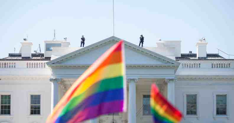 Pride flags are waved in front of the White House.
