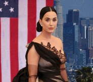 Katy Perry in a black gown in front of the Us flag