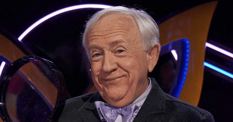 Leslie Jordan holding a magnifying glass on The Masked Singer