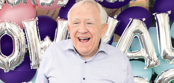 Leslie Jordan standing in front of balloons