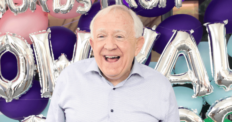 Leslie Jordan standing in front of balloons