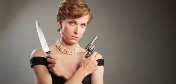 A publicity photo showing actor and writer Linus Karp as Princess Diana holding a knife and a gun from the new play Diana: The Untold and Untrue Story. (Supplied)