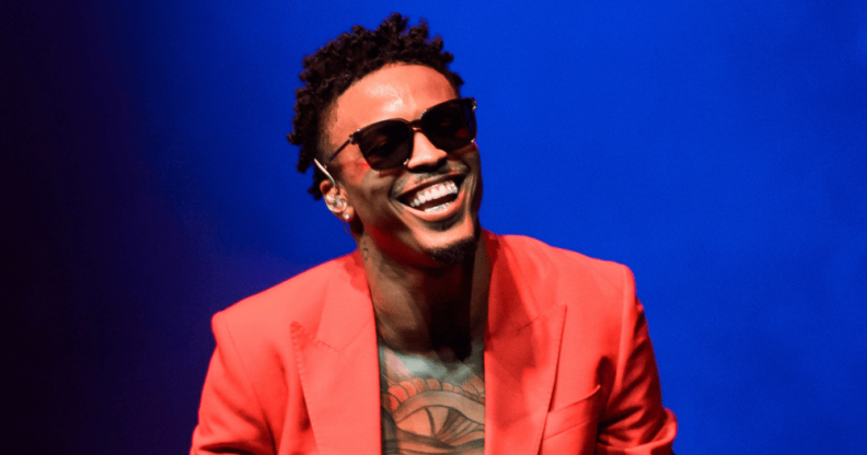 Singer August Alsina performs at the 02 in London wearing a red blazer and black sunglasses