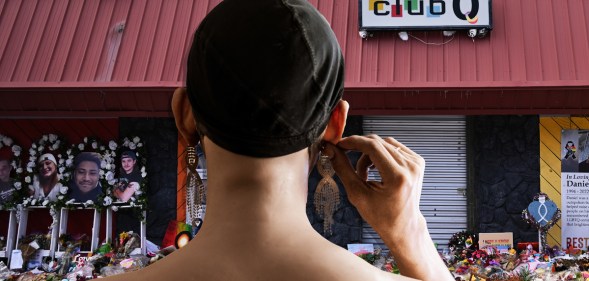 A graphic made up of a photo of Colorado Springs Club Q after the shooting with flowers outside and a figure of a drag artist superimposed with their back to the camera and holding one of their ears - looking like they are staring at the club(Getty)
