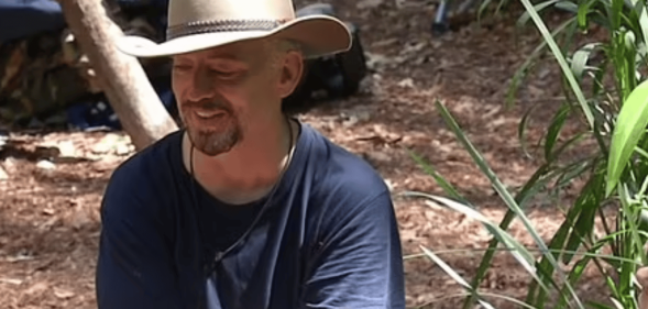 Boy George sat in a clearing in the I'm A Celeb jungle