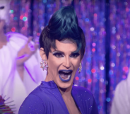 A screenshot of Cynthia Lee Fontaine wearing a purple dress taken from TV show RuPaul's Drag Race