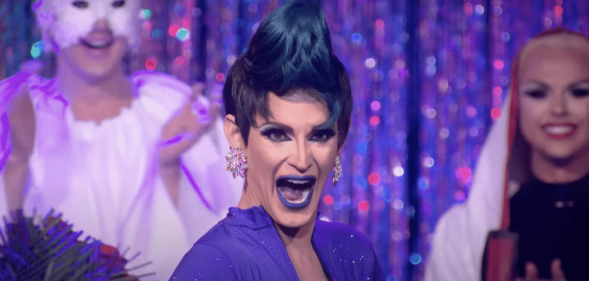 A screenshot of Cynthia Lee Fontaine wearing a purple dress taken from TV show RuPaul's Drag Race