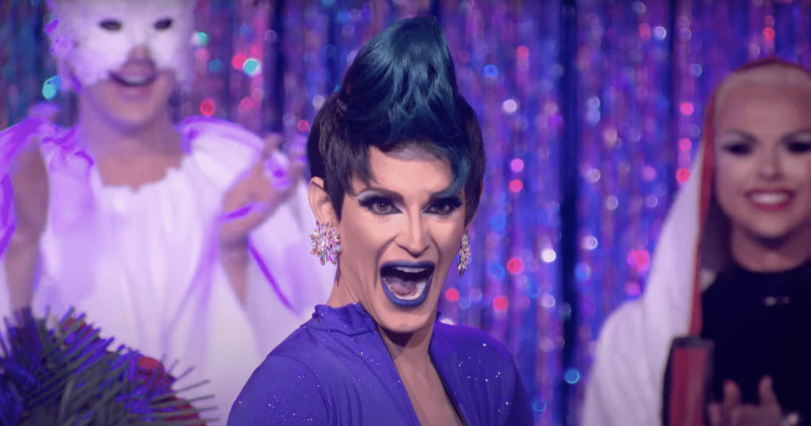 A screenshot of Cynthia Lee Fontaine wearing a purple dress taken from TV show RuPaul's Drag Race