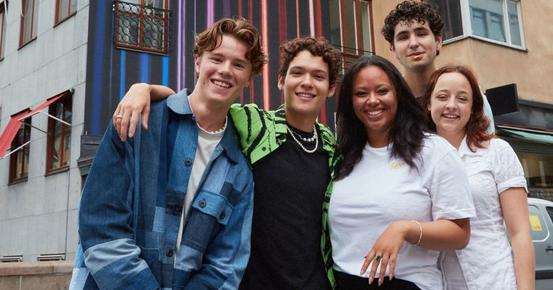 Actors from Netflix series Young Royals in a group publicity shot taken in front of some buildings. (Netflix)