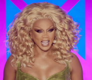 RuPaul laughing at the Drag Race UK judges table
