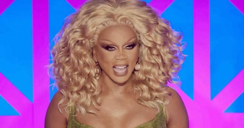 RuPaul laughing at the Drag Race UK judges table