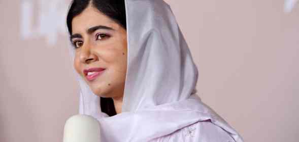 Malala speaking into a microphone