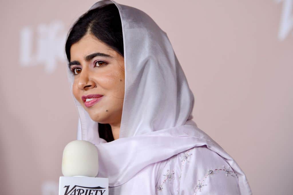 Malala speaking into a microphone