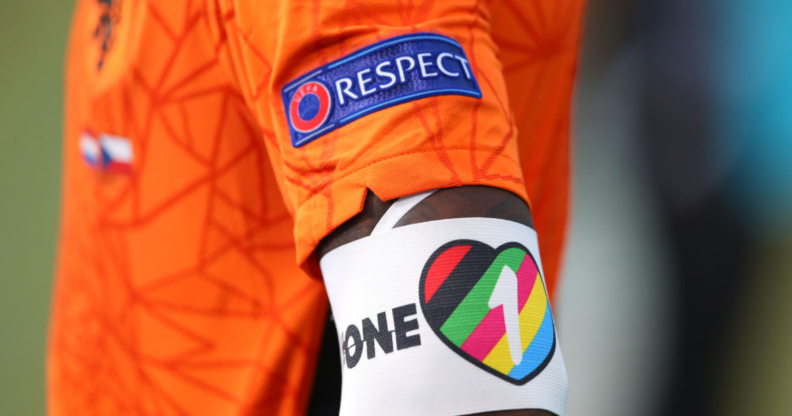 A closeup image of a player's arm from the Netherlands wearing a rainbow OneLove armband