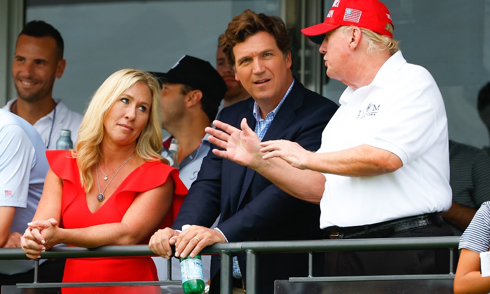 Tucker Carlson watches gold with Marjorie Taylor Greene and Donald Trump.