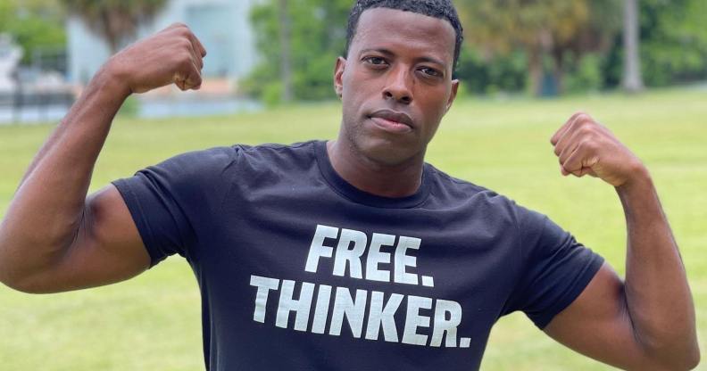 A photo shows gay Iraq war veteranRob Smith standing in a field wearing a t-shrit that reads "free thinker"