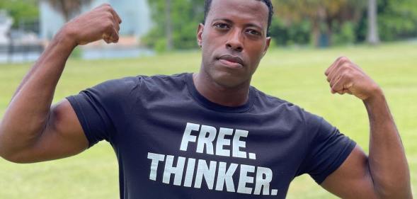A photo shows gay Iraq war veteranRob Smith standing in a field wearing a t-shrit that reads "free thinker"