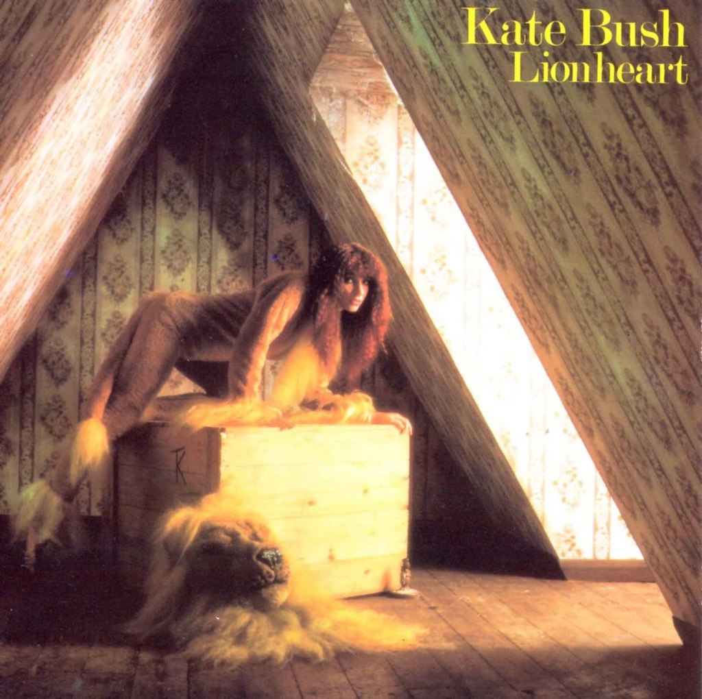 Kate Bush dressed as a lion in a loft perched on a box in the album artwork for Lionheart.