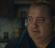 A still from the movie The Whale showing actor Brendan Fraser as obese character Charlie wearing a black shirt