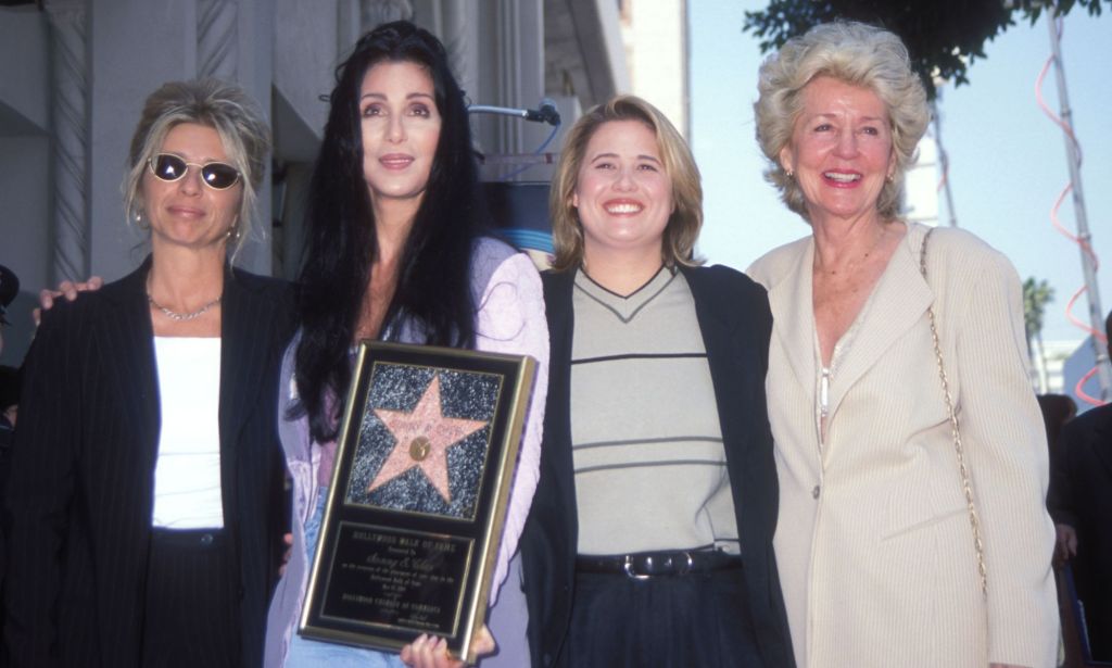 Christy Bono, Cher, Chastity Bono, and Georgia Holt all pose for a picture as Cher holds her Sonny & Cher Walk of Fame award.