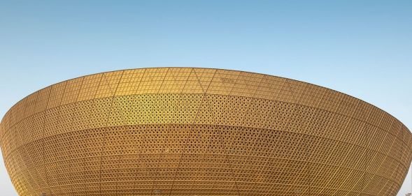 A picture of the golden-brown outer rim of the Lusail stadium in Doha, Qatar