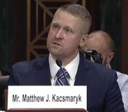 Federal district judge Matthew Kacsmaryk speaks before a judiciary committee wearing a blue suit, with an audience behind him.
