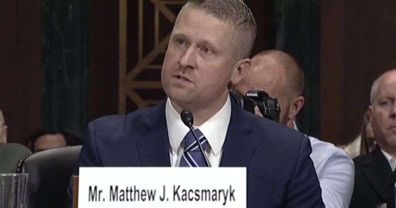 Federal district judge Matthew Kacsmaryk speaks before a judiciary committee wearing a blue suit, with an audience behind him.