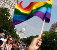 A LGBTQ+ pride flag is seen in front of the US capitol building