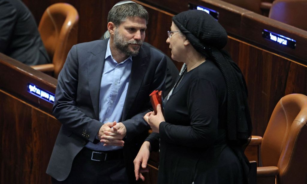 Israeli Knesset member Bezalel Smotrich (L), leader of the Religious Zionist Party, speaks with his colleague and party member Orit Strook (R) during a session elect