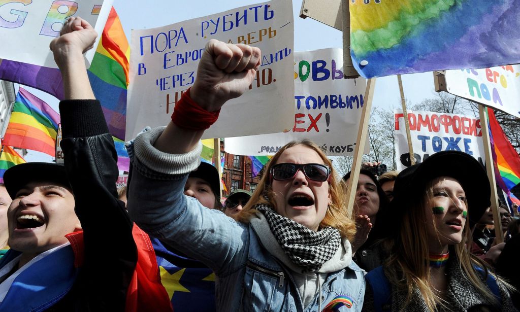 A photo of LGBTQ+ activists holding placards taking part in a May Day rally in Saint Petersburg, Russia to protest against anti-LGBTQ+ legislation including a 'gay propaganda' ban