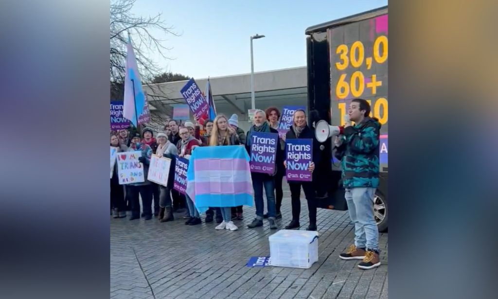 A group of people holding up the trans flags and signs in support of the trans community call on MSPs to pass the Gender Recognition Reform (Scotland) bill