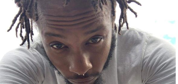 A selfie photo of Mar'Quis Jackson wearing a white t-shirt shows him staring into the camera