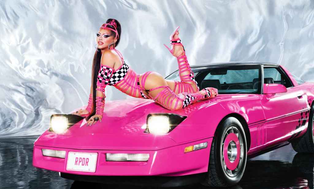A promo shot from RuPaul's Drag Race's fifteenth season showing drag queen Sasha Colby lying on the front of a pink sports car