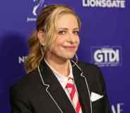 Headshot of actress Sarah Michelle Gella wearing a school-type blazer uniform outfit with red and white striped tie as she poses at the The Wrap's Power of Women Summit event in Los Angeles