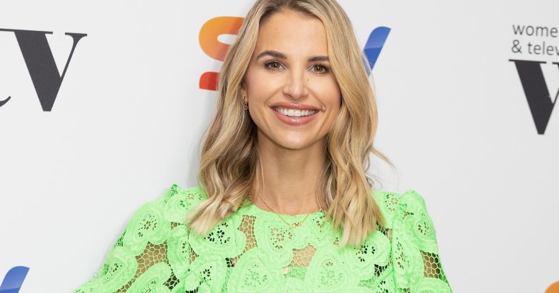 A photo of model and TV presenter Vogue Williams wearing a green top as she poses for a photo at a Sky TV event