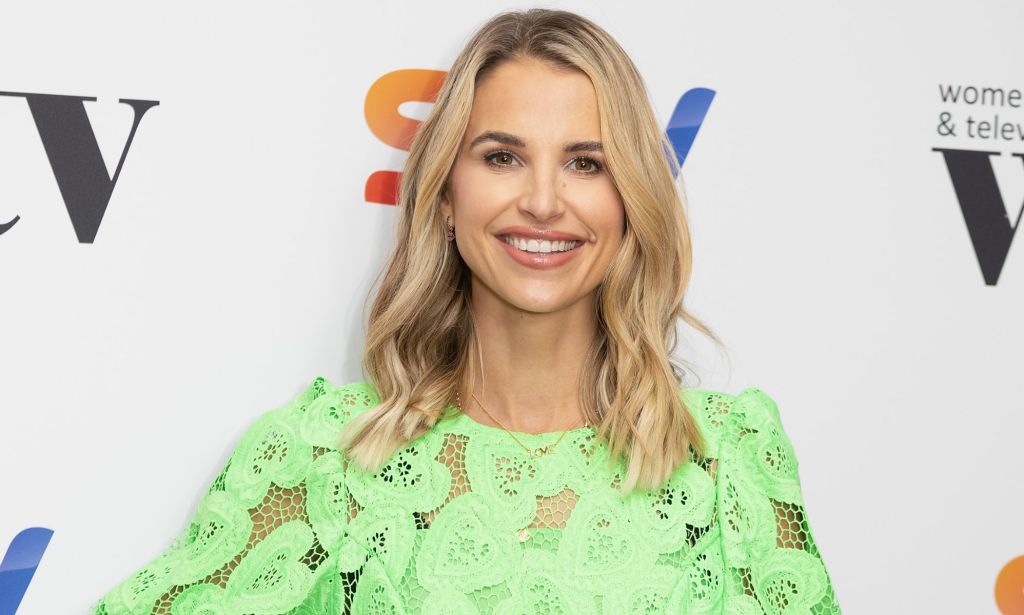 A photo of model and TV presenter Vogue Williams wearing a green top as she poses for a photo at a Sky TV event