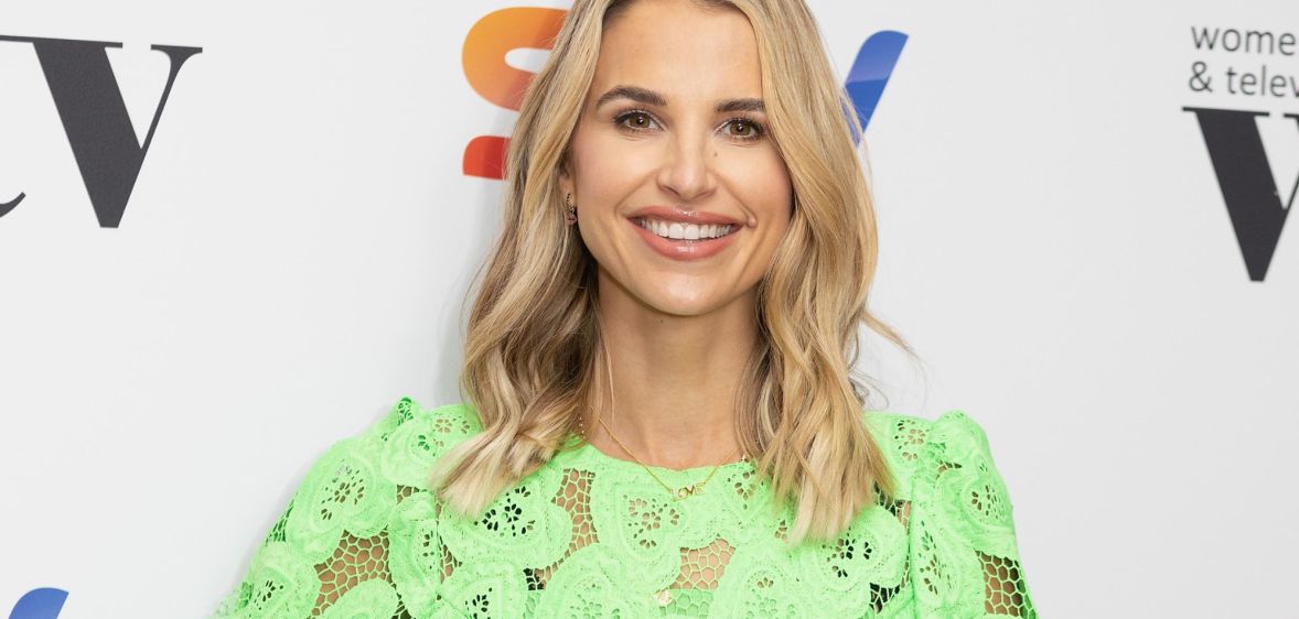 A photo of model and TV presenter Vogue Williams wearing a green top as she poses for a photo at a Sky TV event