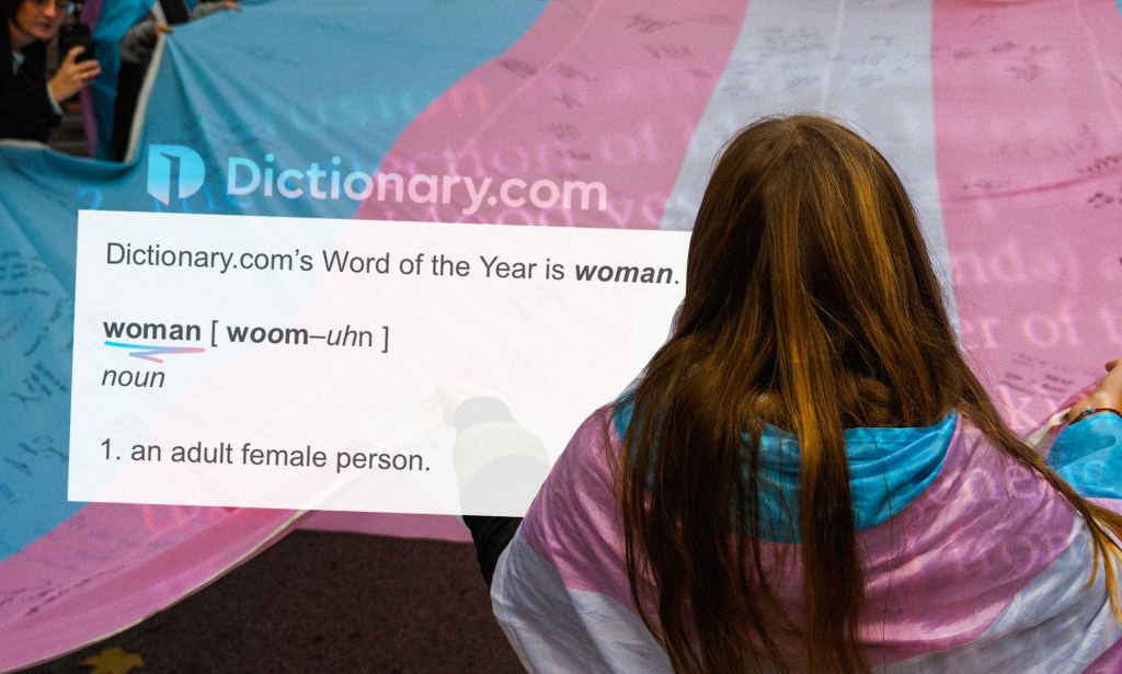 A woman stands with her back to the camera, wearing a trans flag while the dictionary definiton of the word woman is next to her.