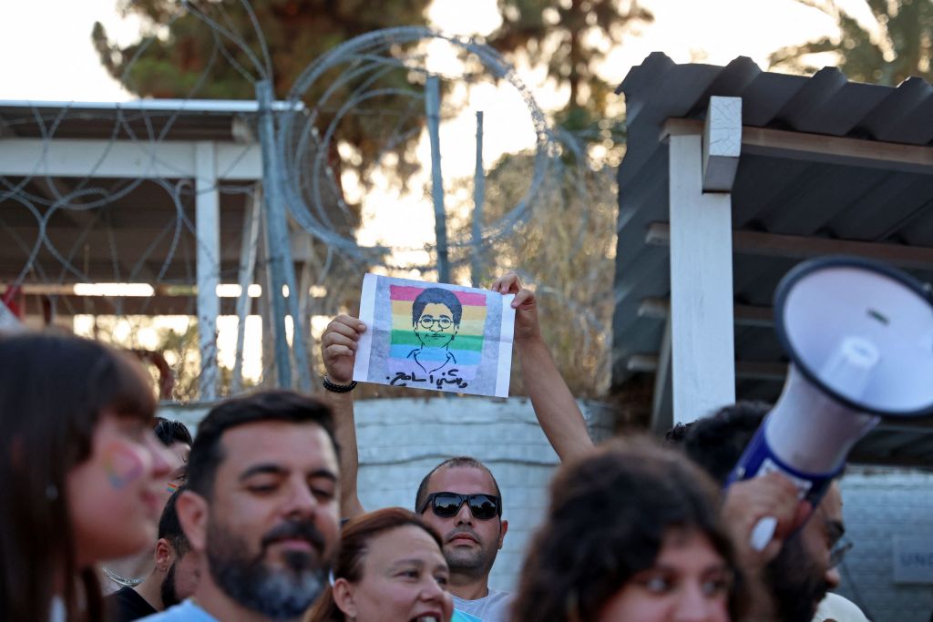 A participant holds up a silhouette picture depicting the late Egyptian LGBTQI activist Sarah Hegazi coloured with the rainbow flag during Cyprus' first intercommunal pride parade at the United Nations' buffer zone. 