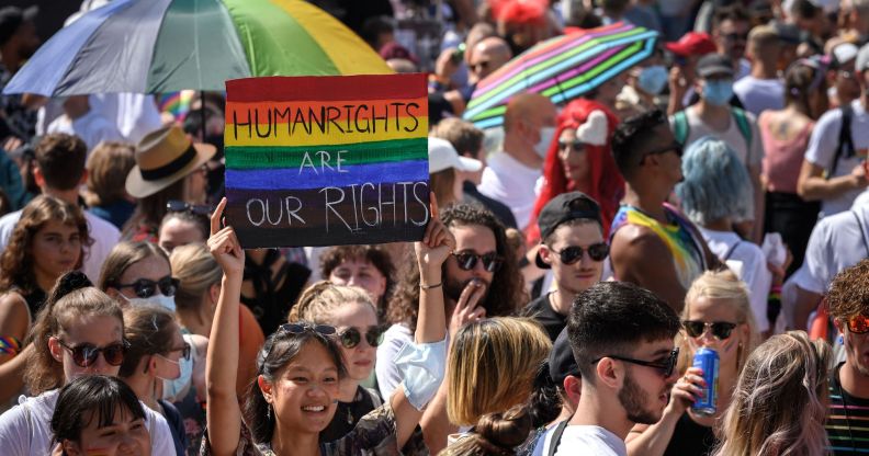 A participant at Pride in Zurich, Switzerland, holds a sign that reads "human rights are our rights"